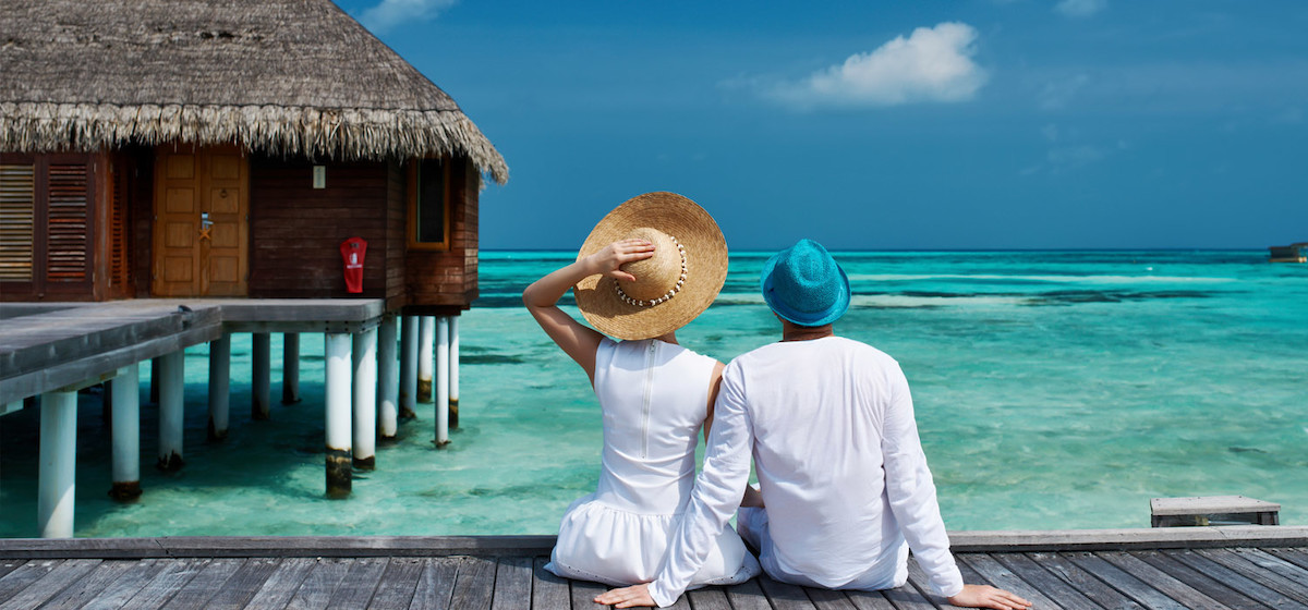 Luxury overwater resort villa with turquoise lagoon view